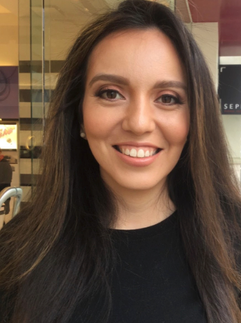 Head shot of Bianca Gallegos with long brown hair and smiling